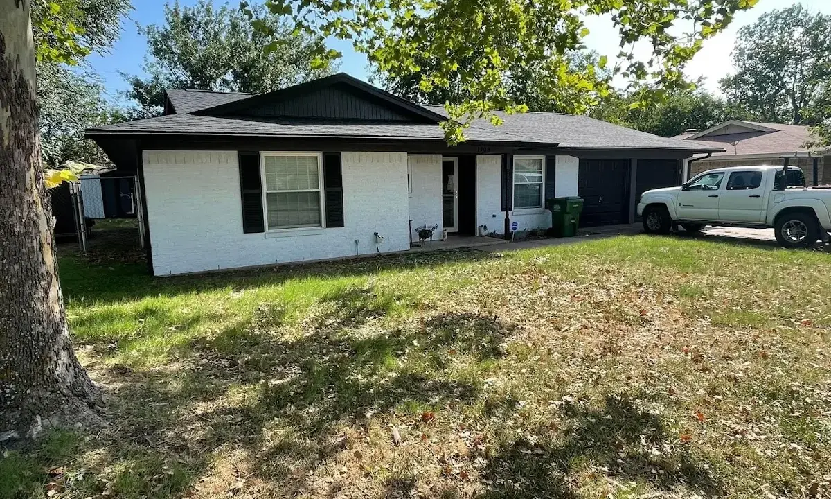 Professional roofing crew working on a residential roof in Lumberton